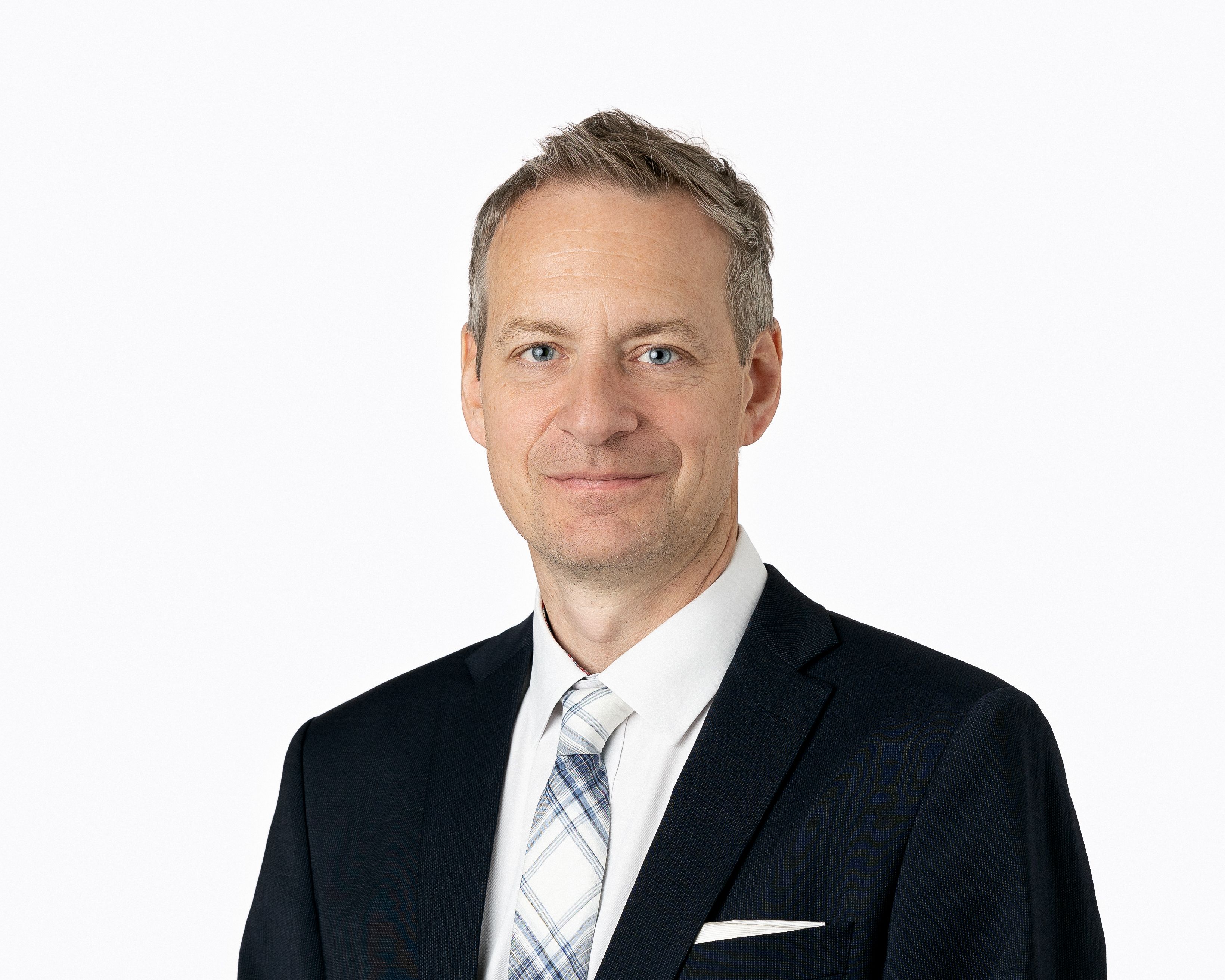 White man in black suit jacket with short cut hair 