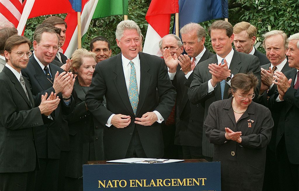 U.S. president Bill Clinton and invited dignitaries celebrate the ratification of NATO enlargement in a ceremony at the White House in Washington, DC. In signing the document, the president officially granted approval to admit Hungary, Poland, and the Czech Republic to the NATO alliance. (Photo by Paul J. Richards/AFP via Getty Images)