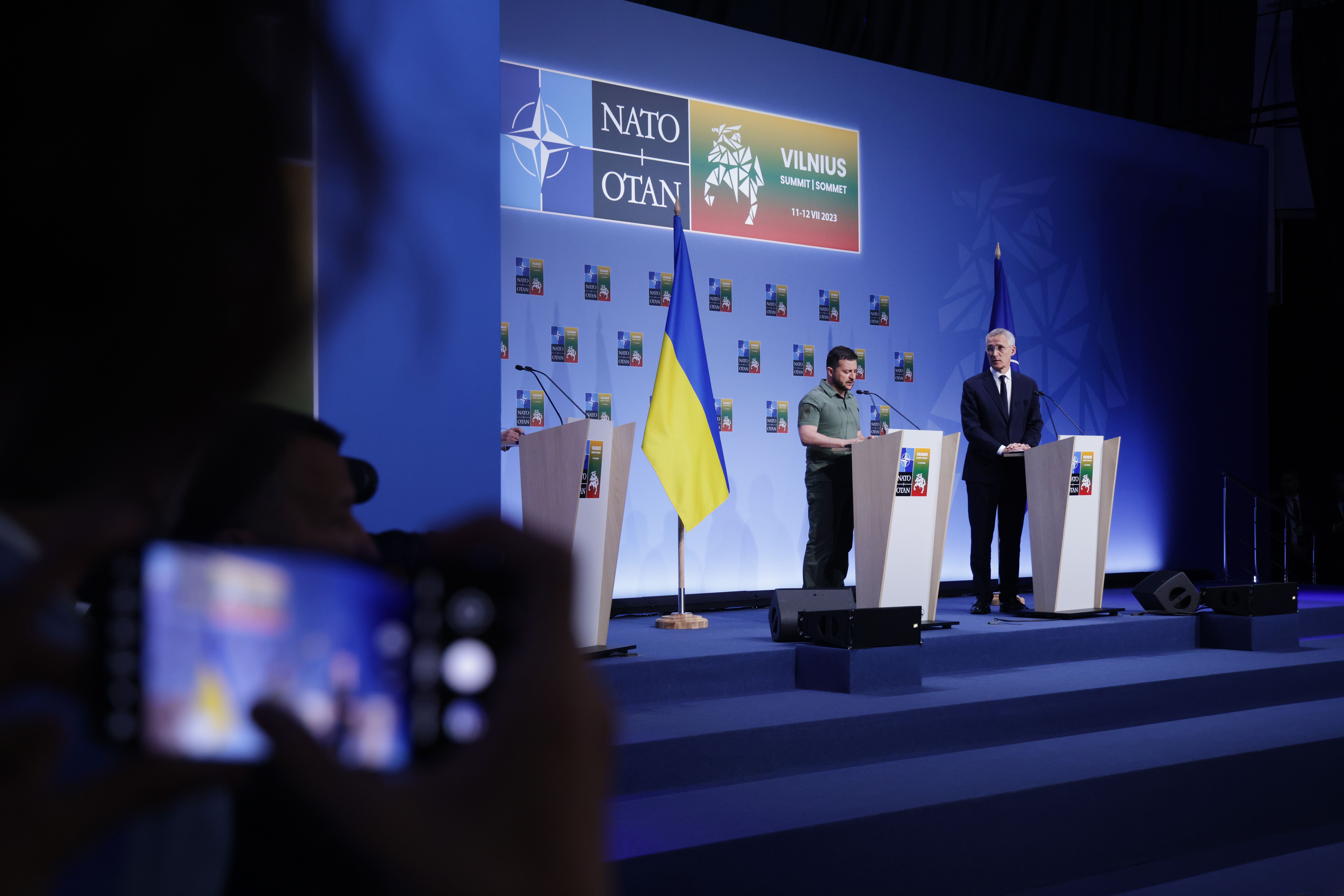 Ukrainian President Volodymyr Zelensky (C) and NATO Secretary General Jens Stoltenberg speak to the media on the second day of the 2023 NATO Summit on July 12, 2023 in Vilnius, Lithuania. The summit is bringing together NATO members and partner countries heads of state from July 11-12 to chart the alliance's future, with Sweden's application for membership and Russia's ongoing war in Ukraine as major topics on the summit agenda. (Photo by Sean Gallup/Getty Images)