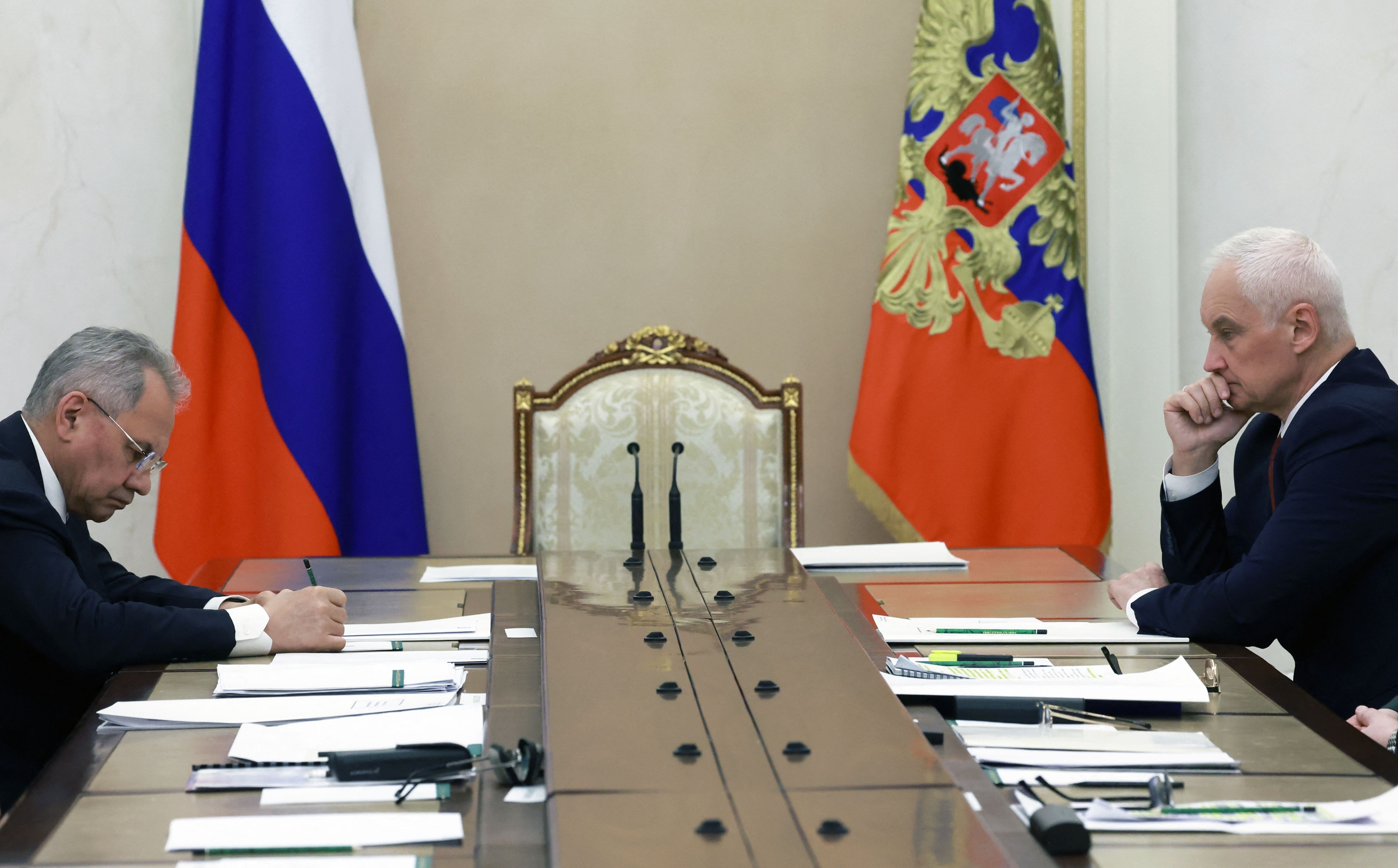 New Defense Minister Andrei Belousov sits with his predecessor, former Defense Minister and current Security Council Secretary Sergei Shoigu