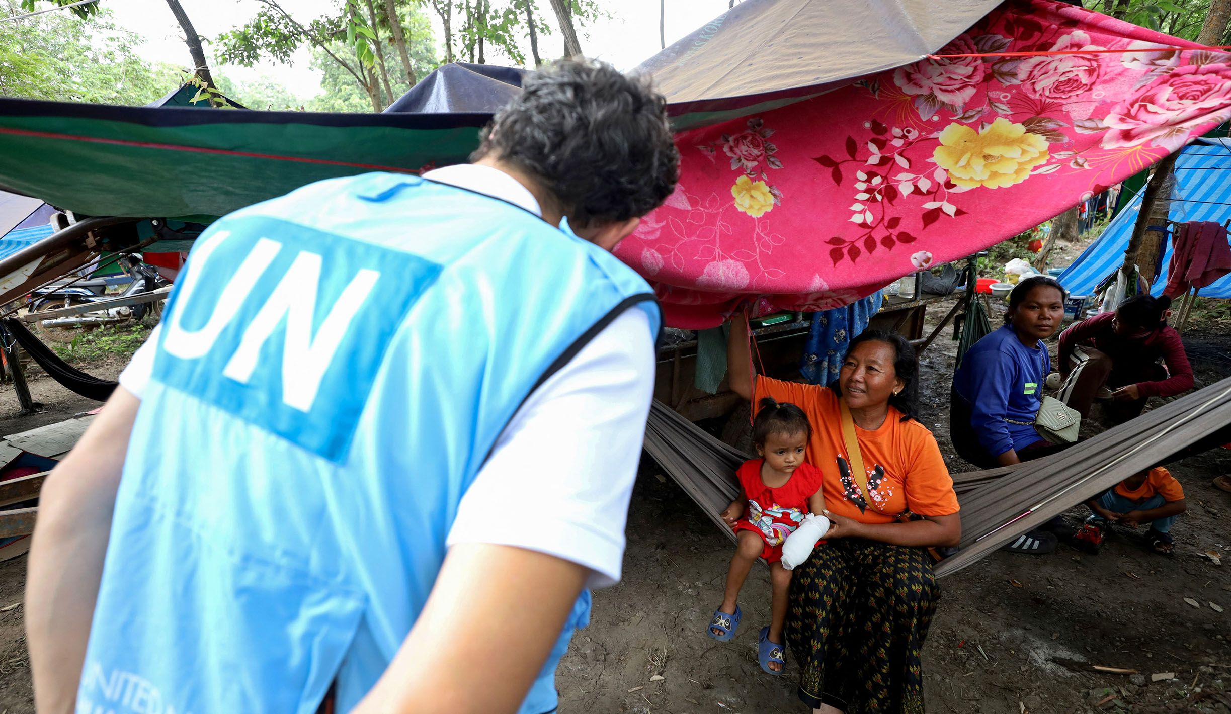 This pool photo taken and released on August 6, 2025 by Agence Kampuchea Presse (AKP) shows a delegation of diplomats from 11 countries along with representatives from 15 United Nations agencies and affiliated organisations visiting the Wat Phnom Thmar Kambor refugee camp in Banteay Ampil district in Cambodia's border province of Oddar Meanchey, to assess humanitarian conditions of displaced civilians following border clashes with Thailand. (Photo by POOL / AFP) (Photo by STR/POOL/AFP via Getty Images)