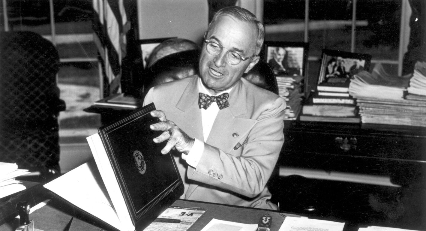 Photo of Harry Truman reviewing the UN Charter.