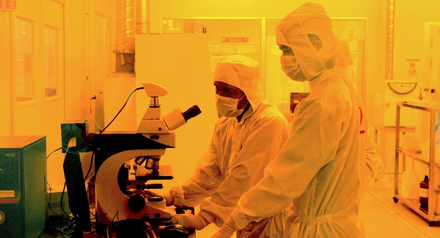 Researchers wearing bunny suits work inside the semiconductor fabrication lab at the Centre for Nano Science and Engineering (CENSe) in India