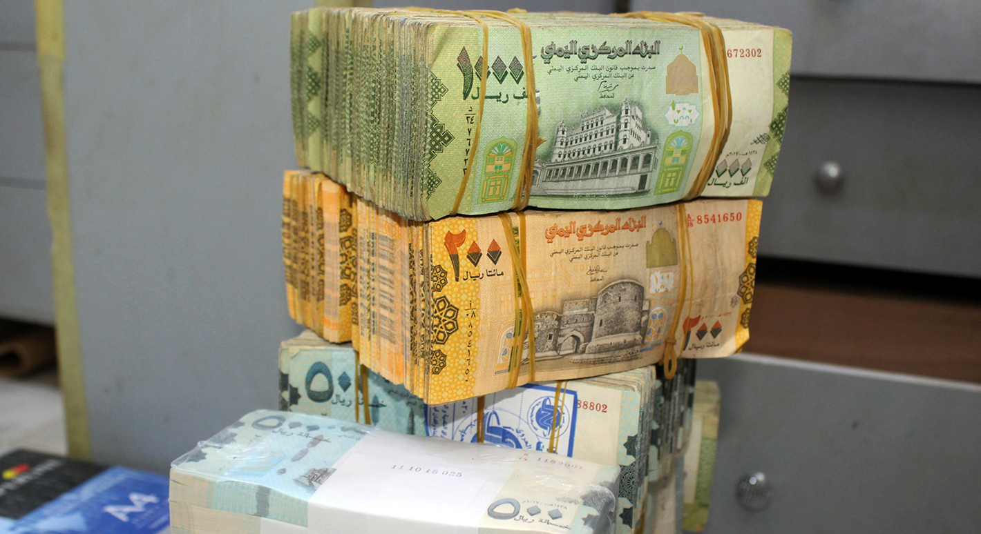 Old and new Yemeni bank notes are pictured at a money exchange office in the southern port city of Aden on January 23, 2020