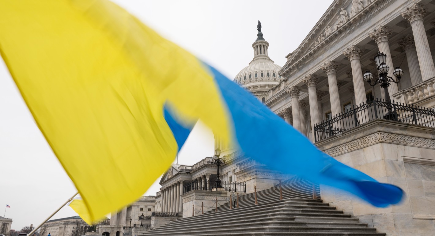 A Ukrainian flag being waved with U.S. capitol in background