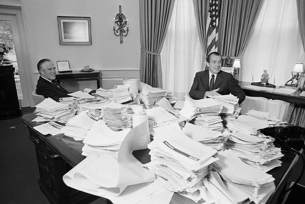 U.S. president Richard Nixon in the oval office surrounded by telegrams from around the country espousing support for his Vietnam withdrawal policy. (Photo by Bettmann Archive/Getty Images)