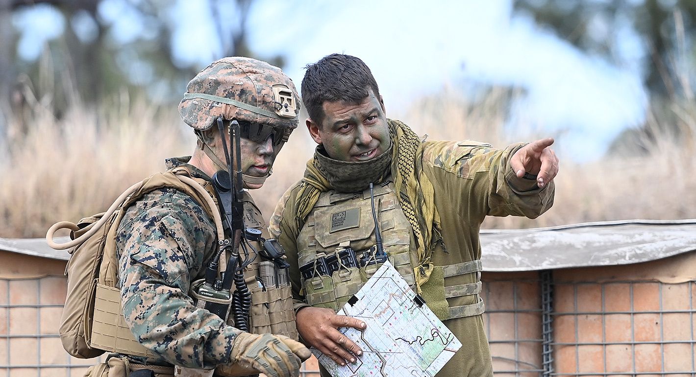  U.S Marine from MRF-D (Marine Rotaional Force Darwin) and an Australian soldier from 'Battle Group Eagle' discuss tactics during an Urban assault as part of Exercise 'Talisman Sabre 21' on July 27, 2021 in Townsville, Australia