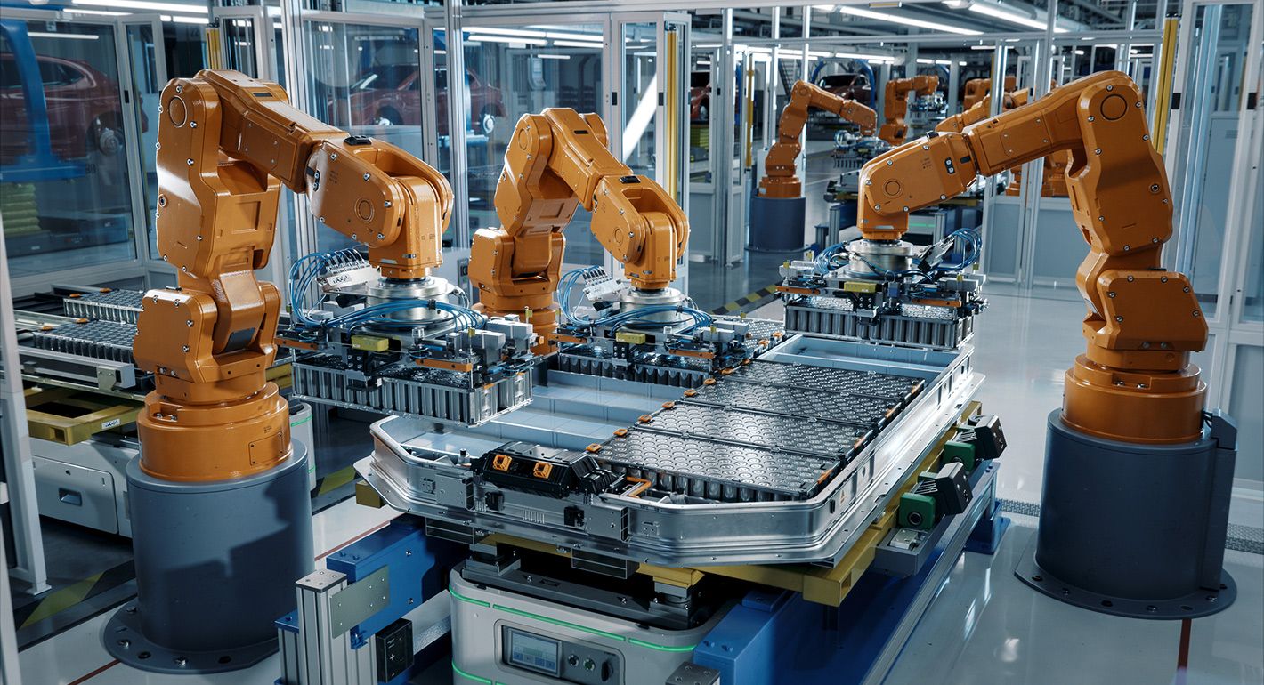 Advanced Orange Industrial Robot Arms Assemble EV Battery Pack on Automated Production Line