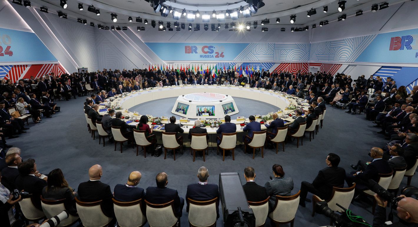 meeting room with a huge circular table and lots of people around it