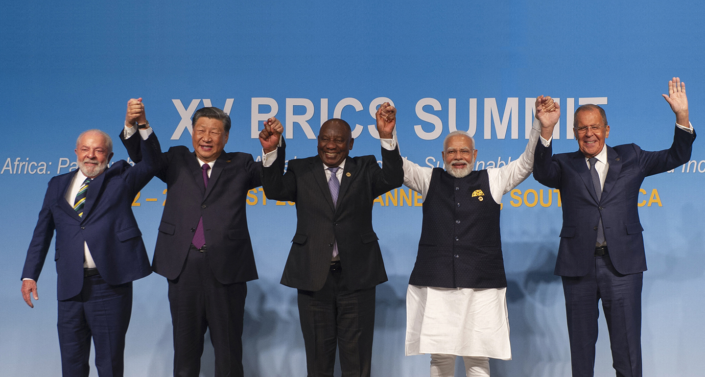 Brazilian President Lula da Silva, Chinese President Xi Jinping, Indian Prime Minister Narendra Modi, South African President Cyril Ramaphosa, and Russian Foreign Minister Sergey Lavrov raise their clasped hands at the 2023 BRICS summit.