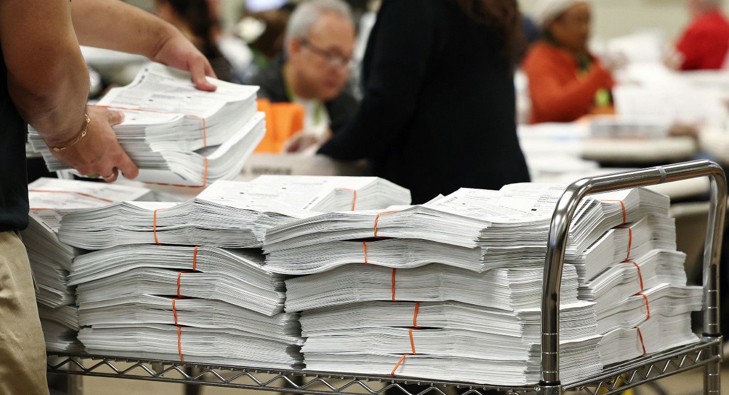 cart with stacks of ballots