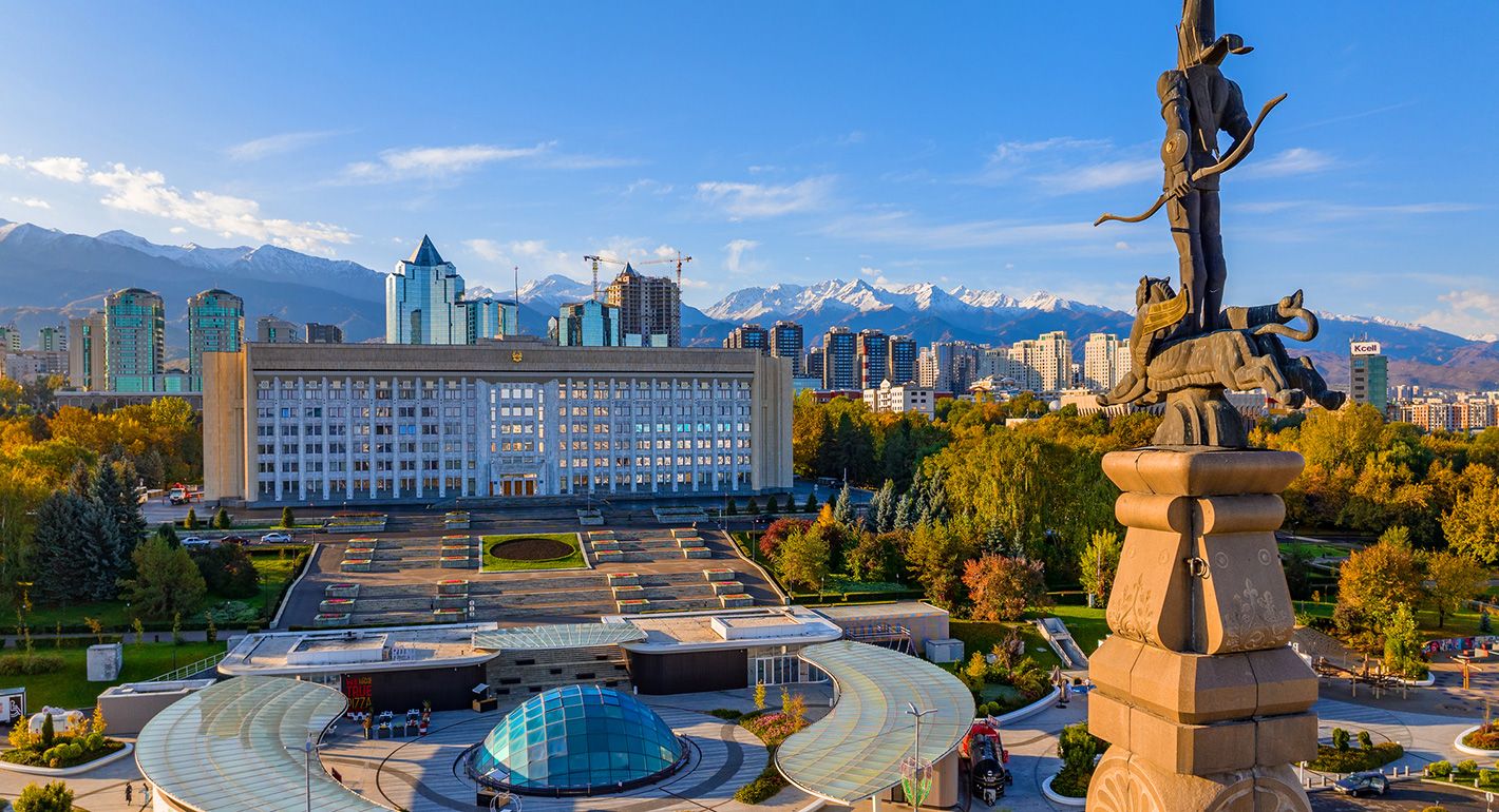 The monument to the independence of Kazakhstan and the akimat (mayor's office) of the city of Alata on an autumn morning