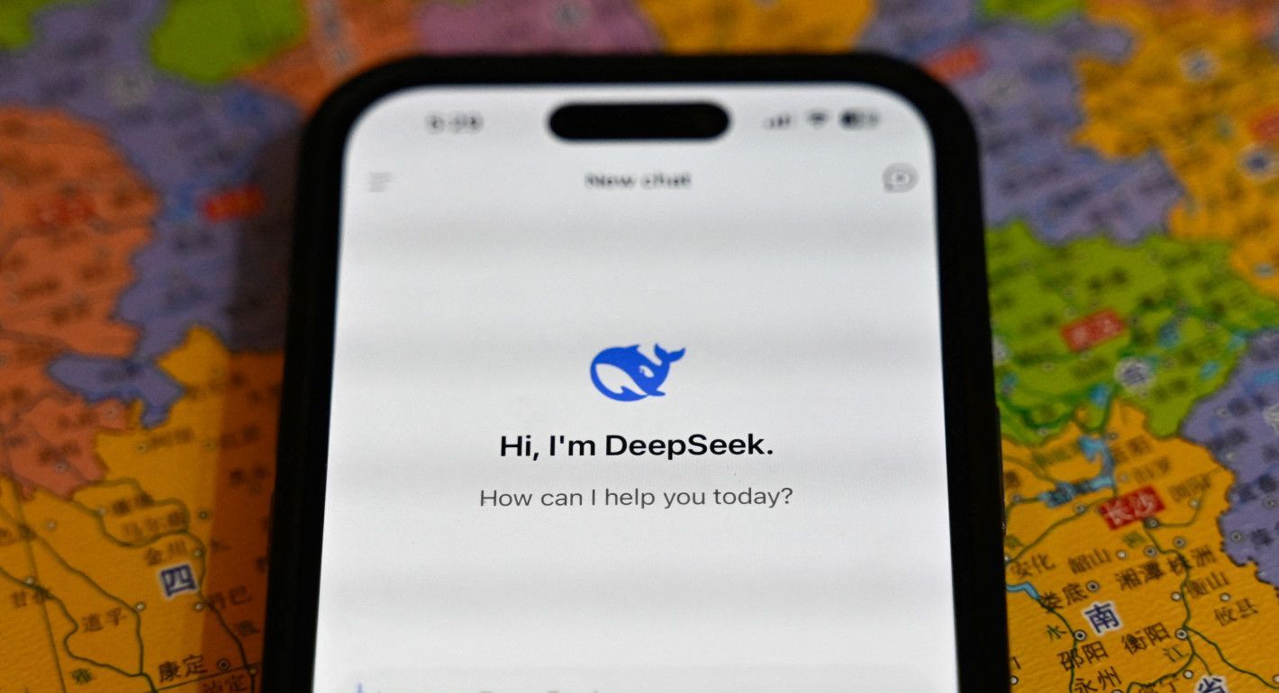 A cellphone showing the DeepSeek app while resting on top of a map of China