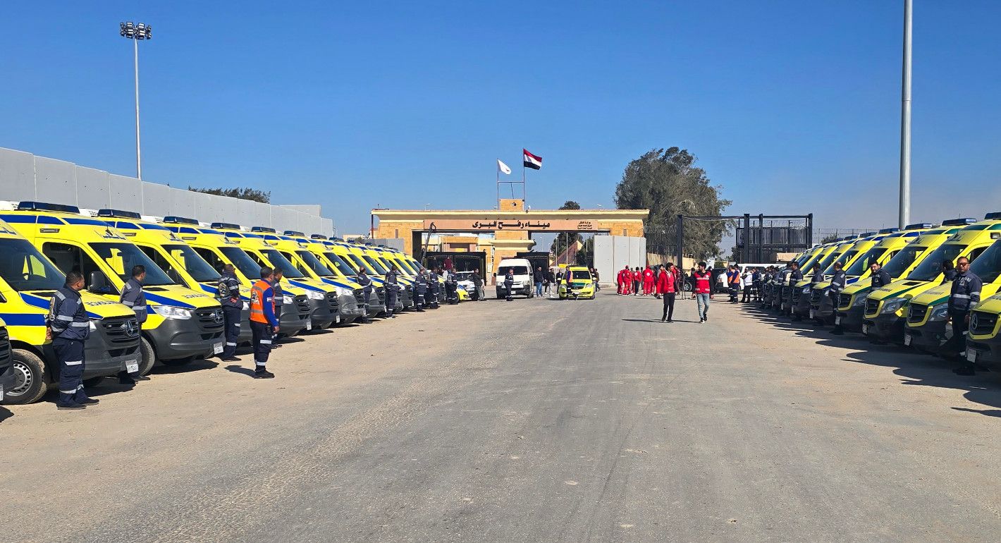 Ambulances lined up outside a gate