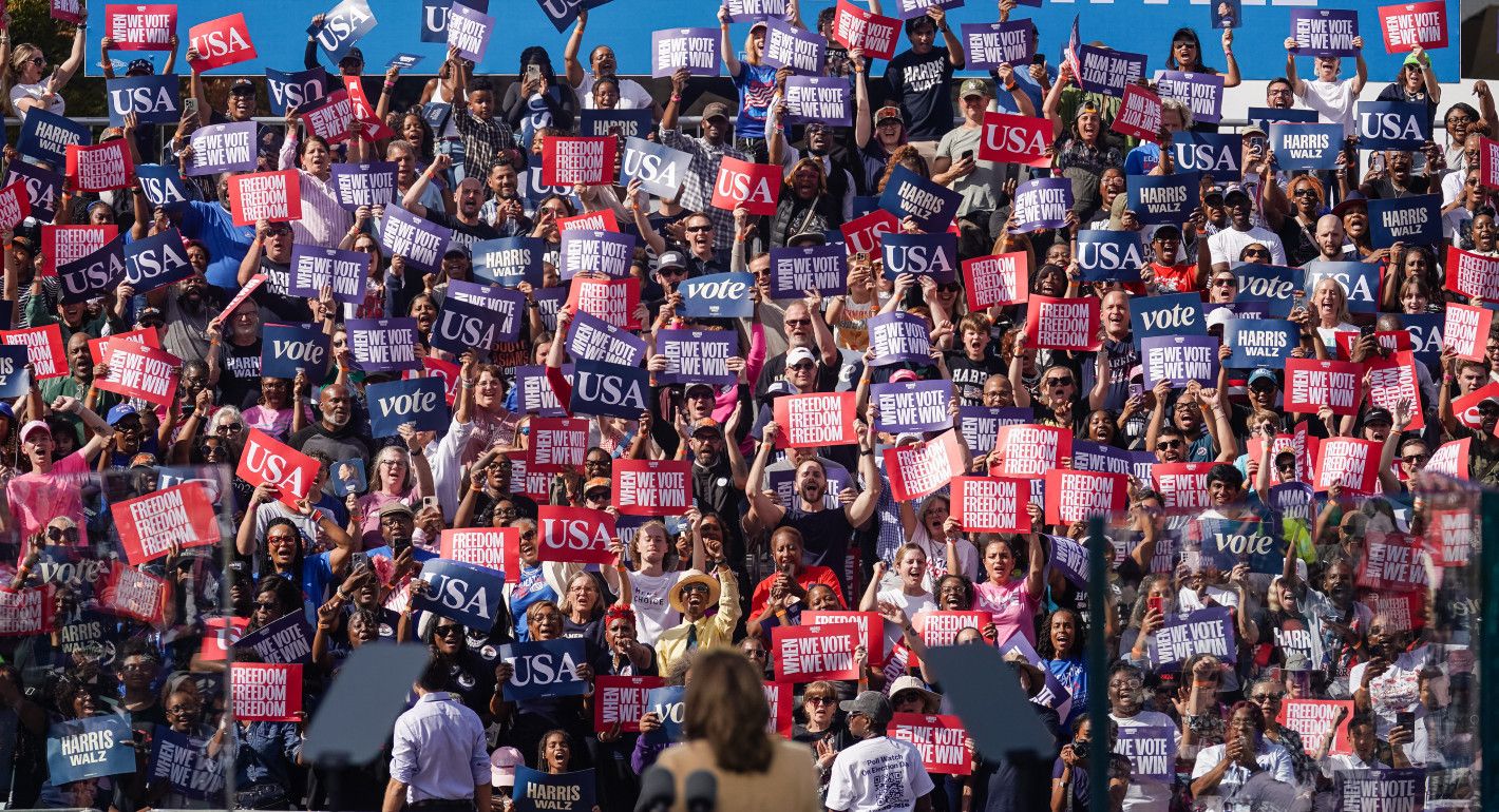 Photo of a crowd of Kamala Harris supporters holding signs at a rally.