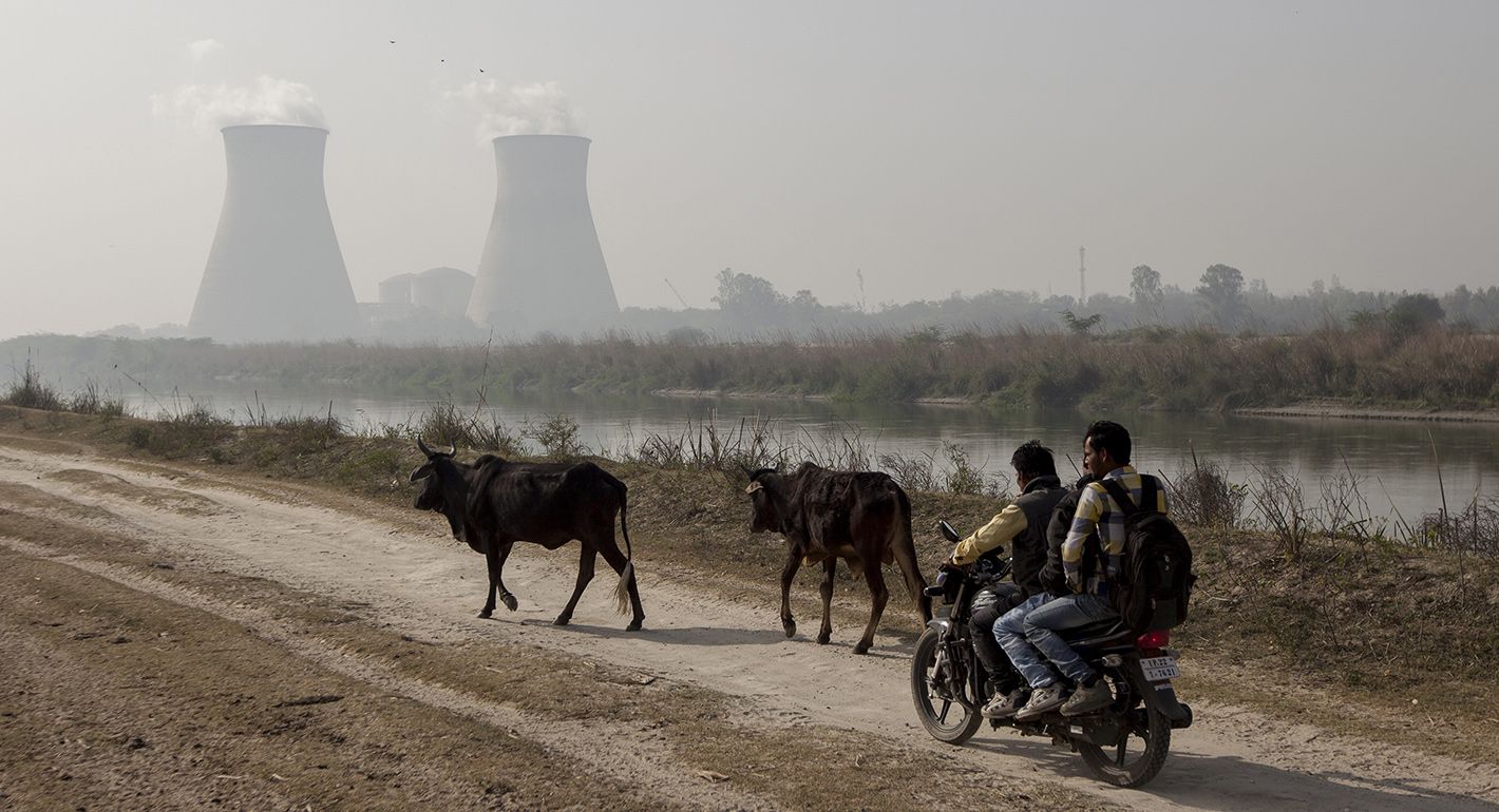 Indian men ride along a dirt road next to the Norora Atomic Power Station near Norora in Uttar Pradesh state on March 27, 2018.  XAVIER GALIANA/AFP via Getty Images