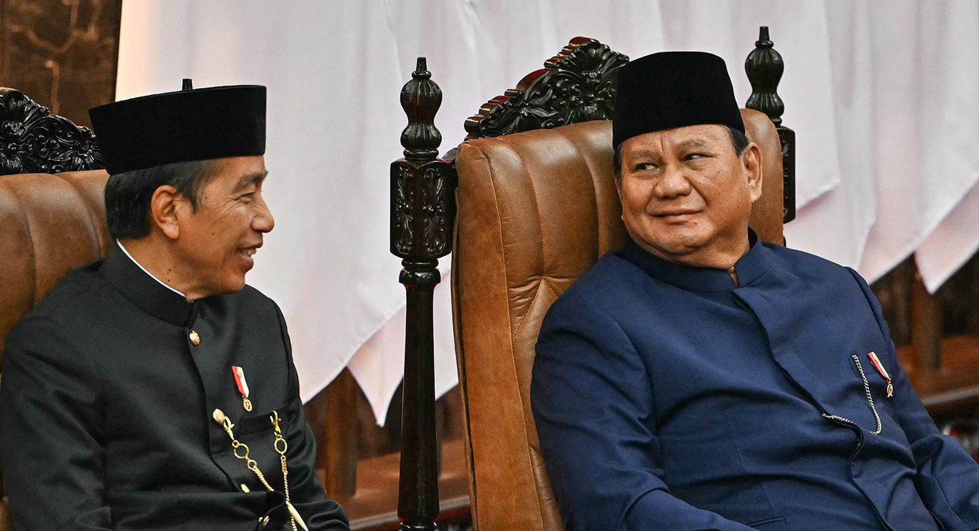 Indonesia's new President Prabowo Subianto (R) and his predecessor Joko Widodo (L) speak during the presidential inauguration ceremony at the Parliament building in Jakarta on October 20, 2024