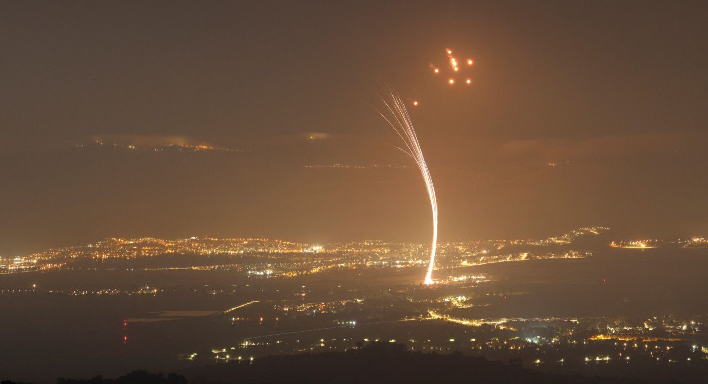 night sky lit up by light from rockets