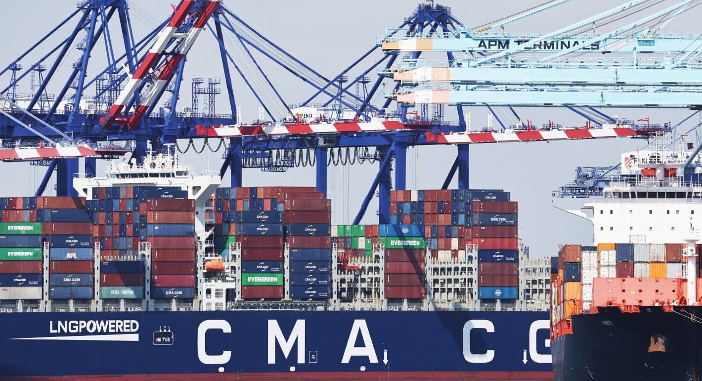 Shipping cranes and a cargo ship stacked with containers