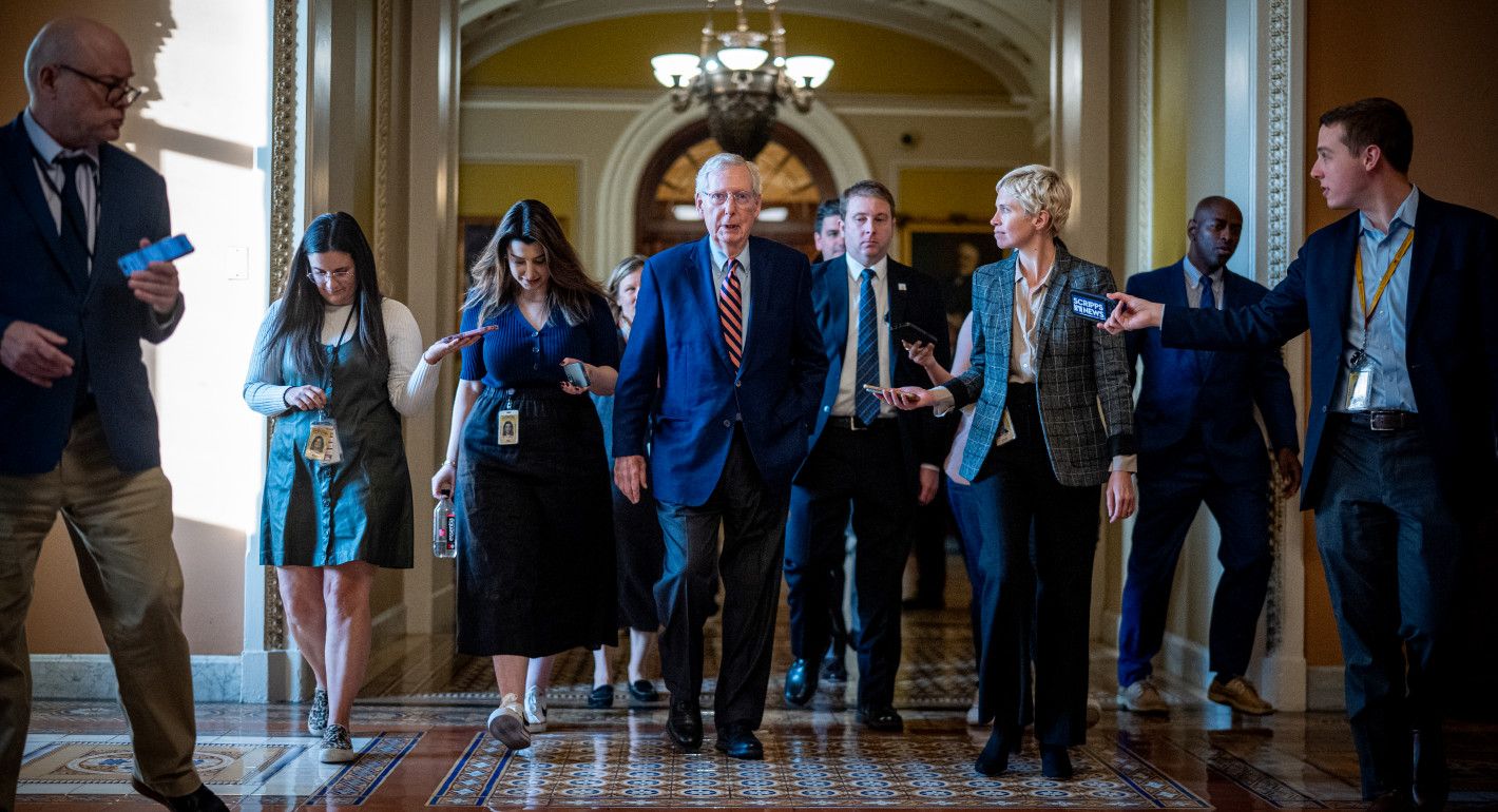 McConnell walking, surrounded by reporters