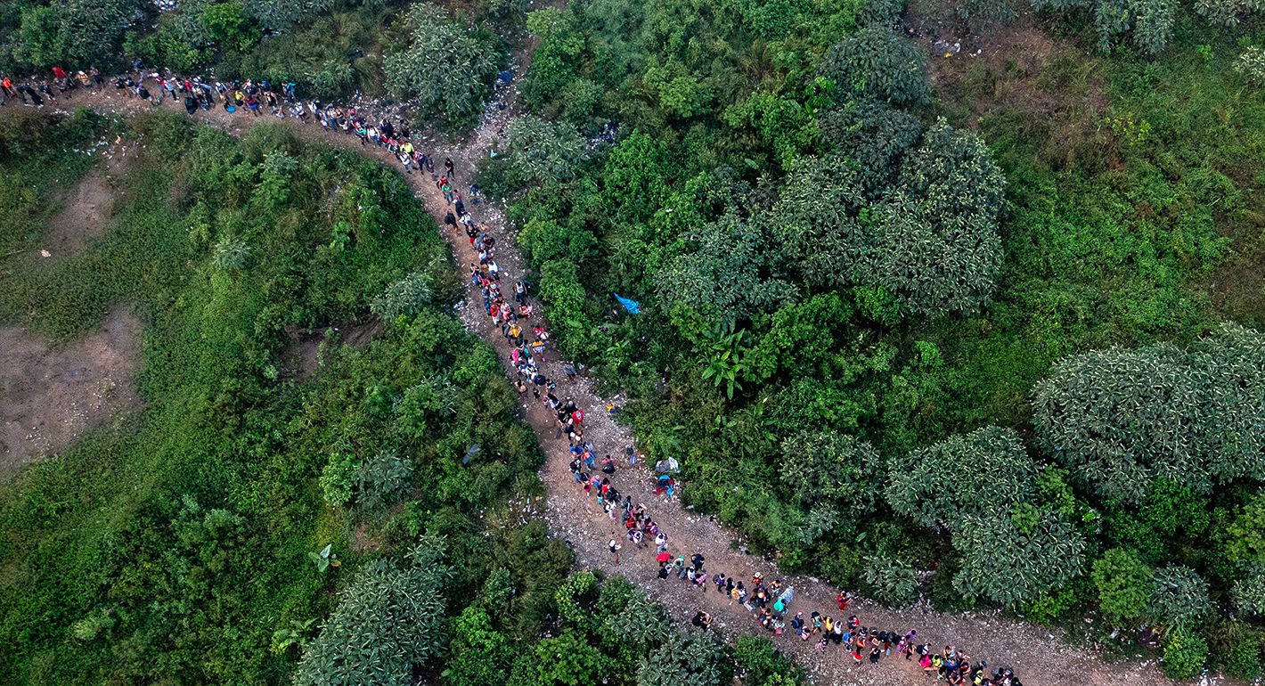 Migrants traveling on a road 