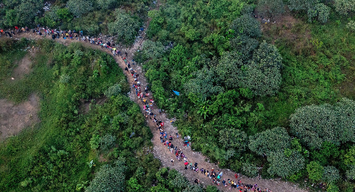 Aerial view showing migrants walking through the jungle near Bajo Chiquito village, the first border control of the Darien Province in Panama, on September 22, 2023. (Photo by Luis Acosta / AFP)