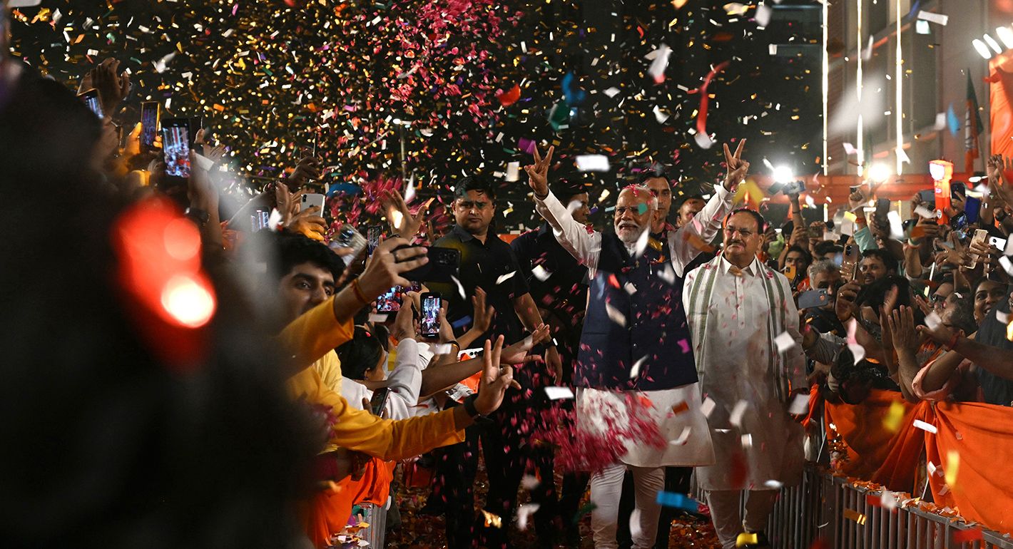 India's Prime Minister Narendra Modi (C) flashes victory sign as he arrives at the Bharatiya Janata Party (BJP) headquarters to celebrate the party's win in country's general election, in New Delhi on June 4, 2024. 