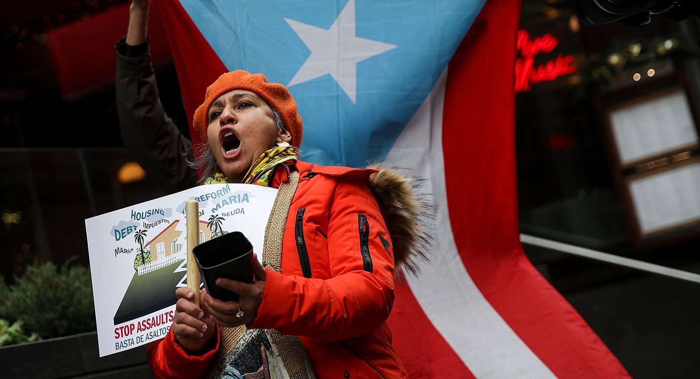 Protestors rally against foreclosures on Puerto Rican families affected by Hurricane Maria, outside the offices of TPG Capital on December 20, 2017 in New York City.