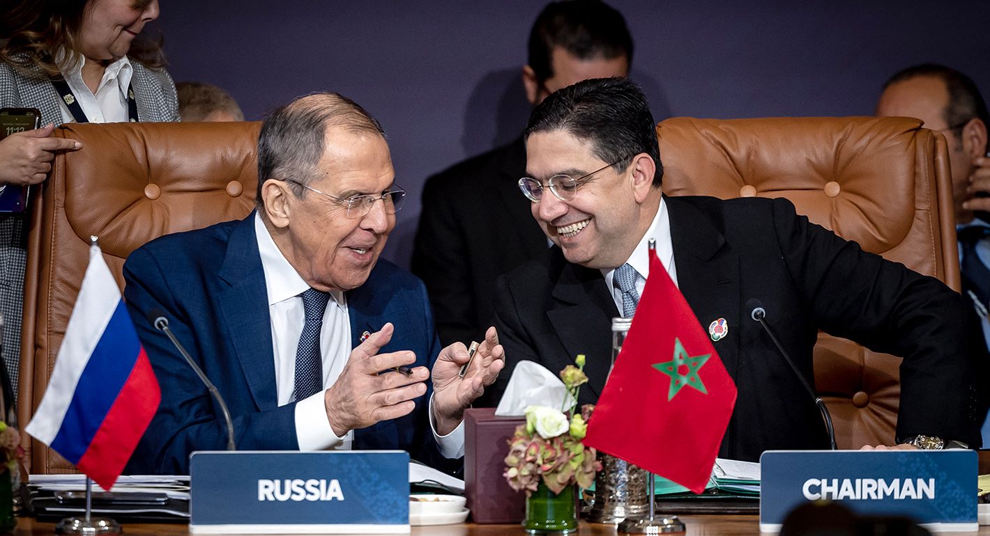 Morocco's Foreign Minister Nasser Bourita (R) shares a laugh with Russia's Foreign Minister Sergei Lavrov during the 6th session of the Arab-Russian cooperation Forum on December 20,2023 in Marrakesh.