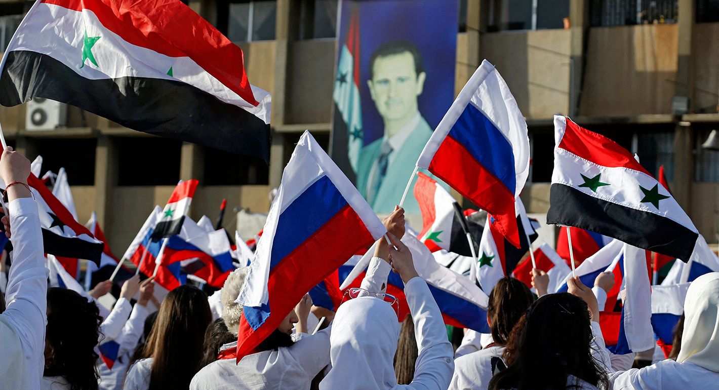 Students wave flags as they gather in support of Russia following the Russian invasion of Ukraine, at the university of Damascus in the Syrian capital, on March 9, 2022. 