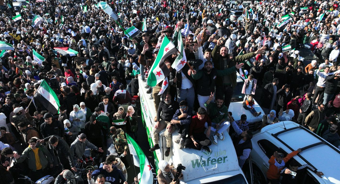 masses of people cheering and waving flags