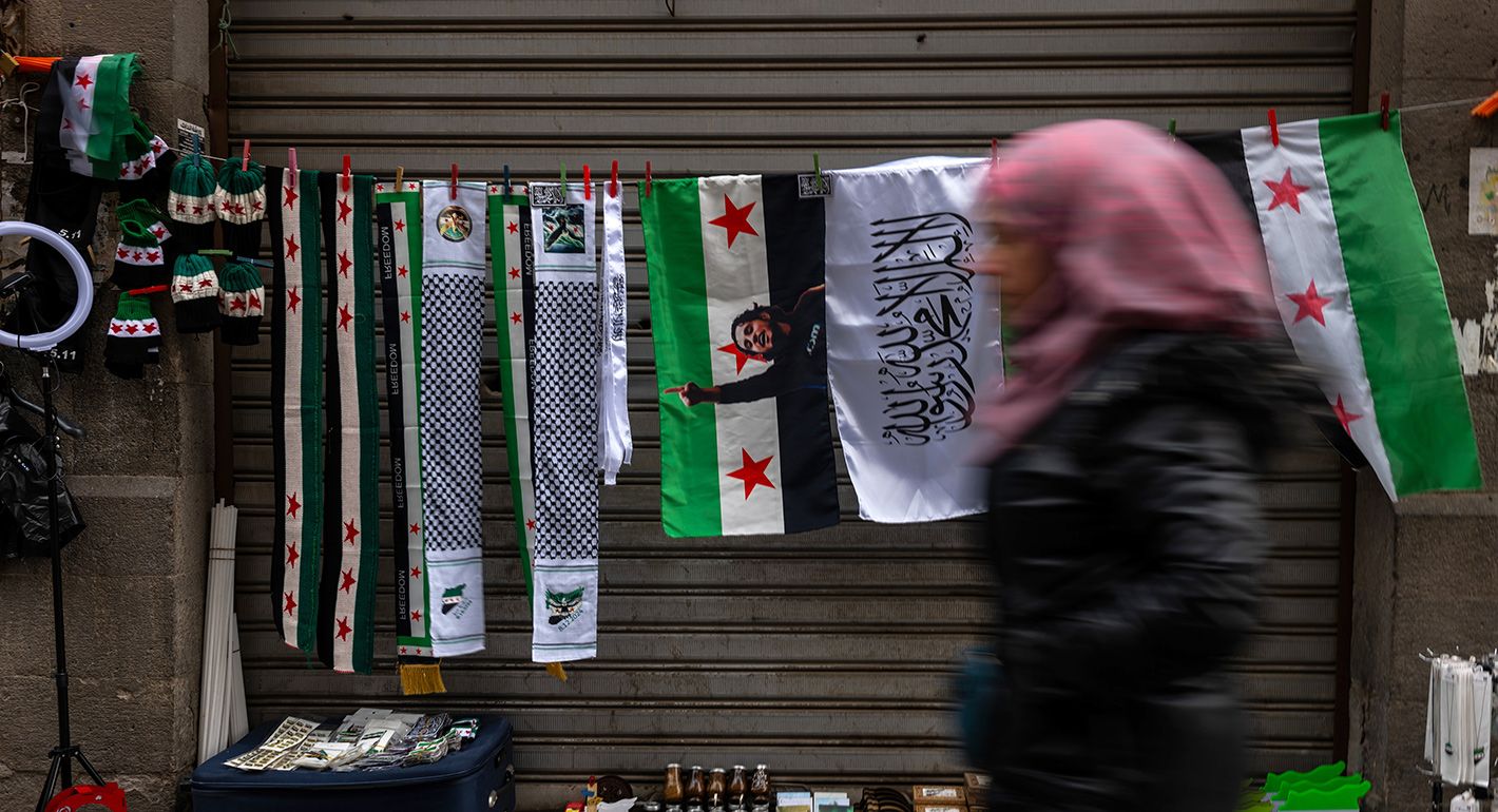 New Syrian flags are sold on a street in the city of Homs on January 22, 2025 in Homs, Syria. 