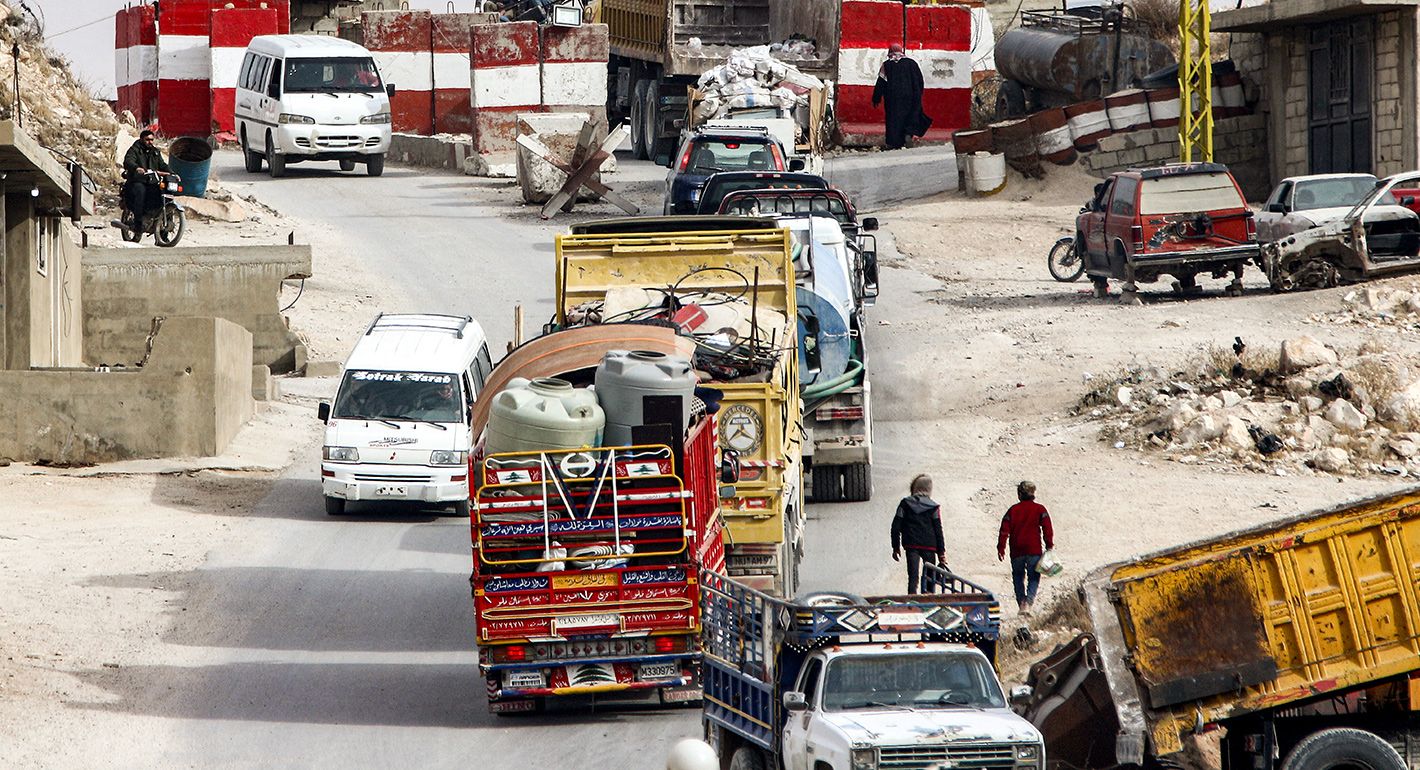 Trucks carrying the belongings of Syrian refugees move along a road from a camp in Arsal in eastern Lebanon on their way back Syria on December 16, 2024