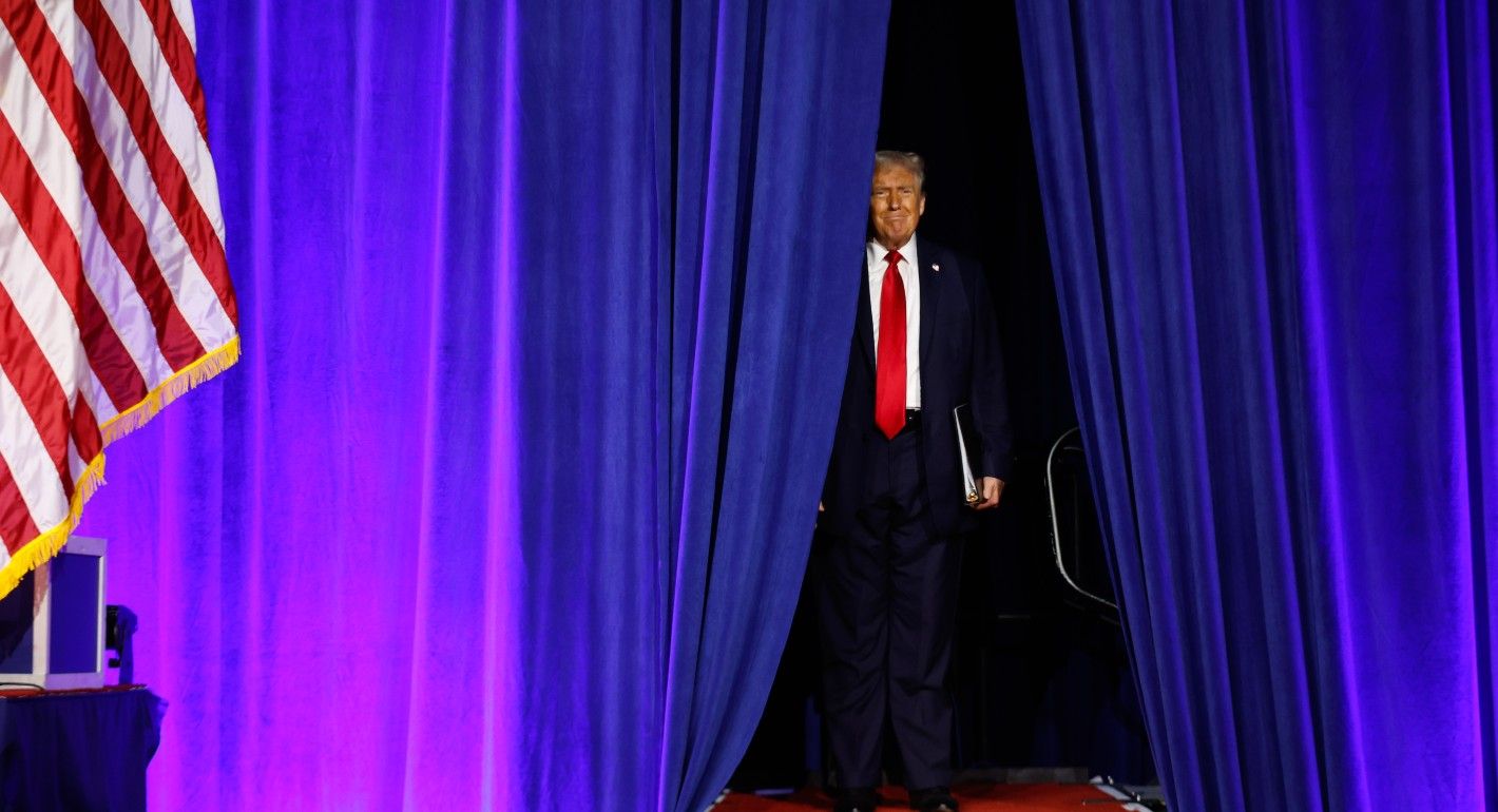 Trump walks through curtain