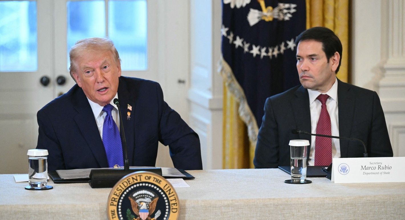 Trump and Rubio sitting at a table facing the camera