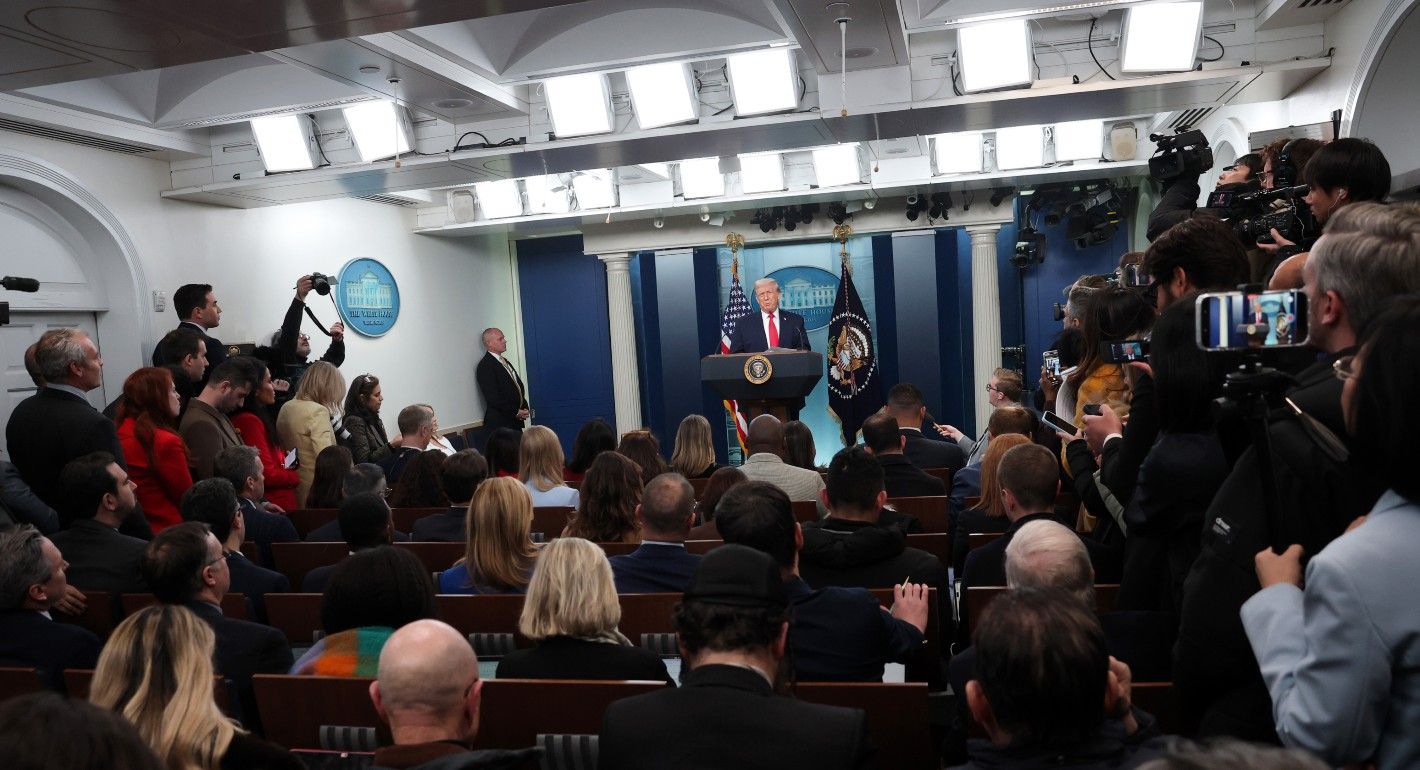 Trump speaking to a room of reporters