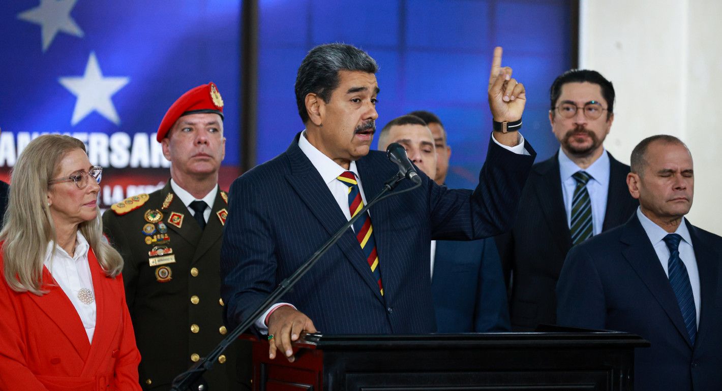 Maduro speaking at a mic and pointing upward