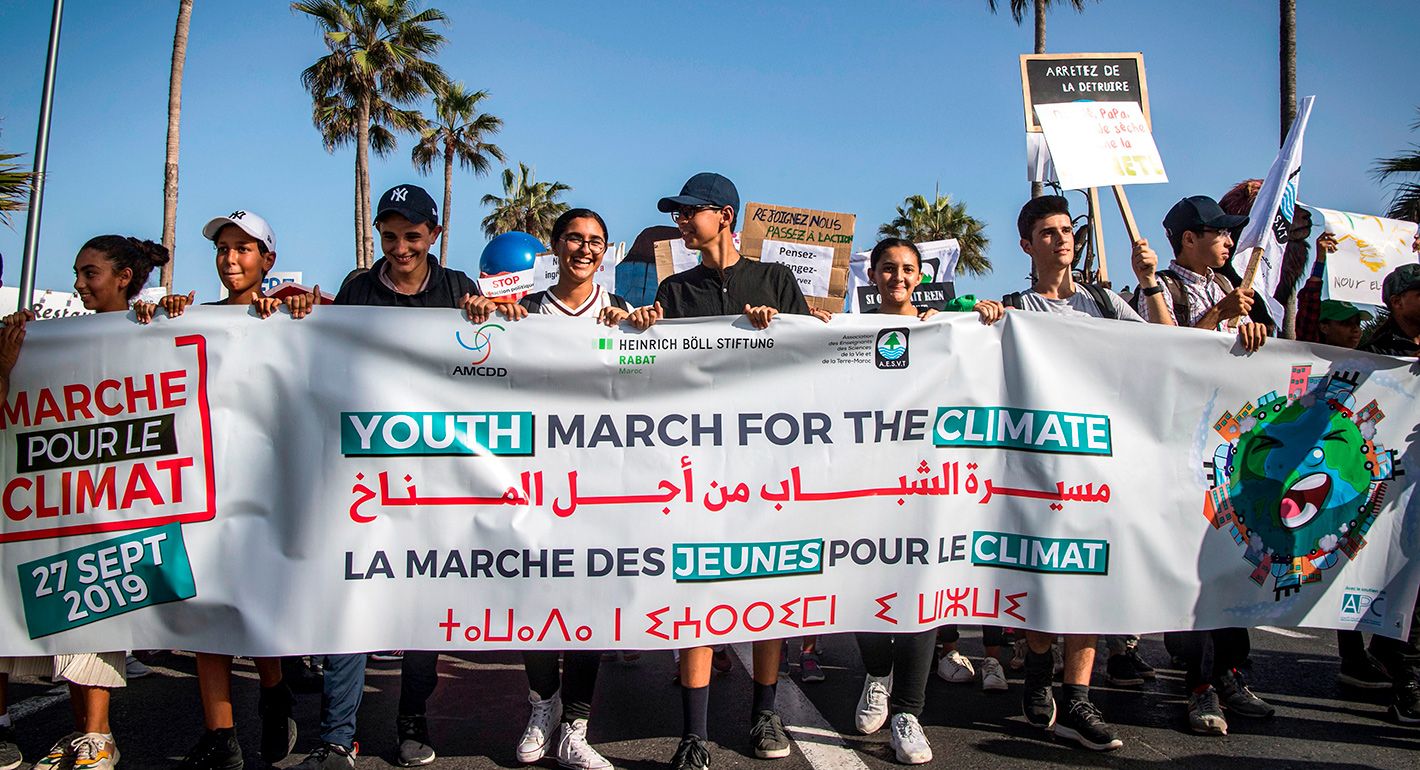 Young people march with a banner as they take part in the "Youth March for the Climate" demonstration, part of a worldwide climate strike against governmental inaction towards climate change and environmental pollution, in Morocco's Atlantic coastal city of Casablanca on September 27, 2019